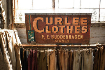 "Curlee Clothes' Metal Sign